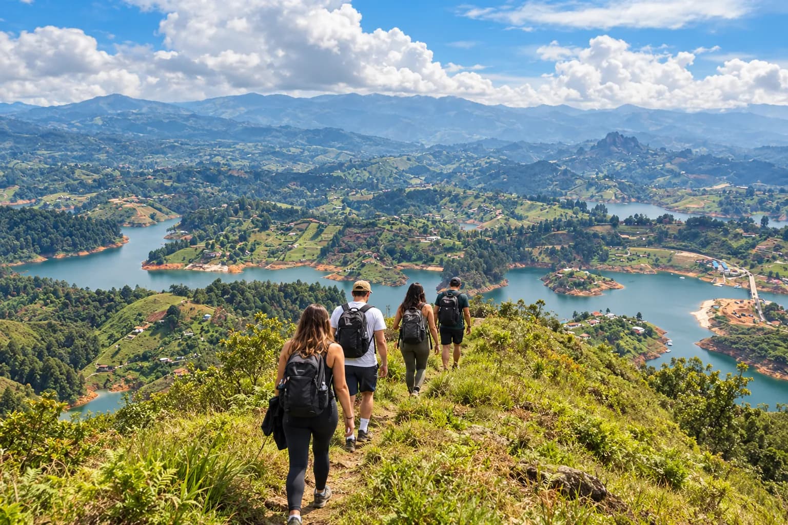 Travelers hiking along a green mountain ridge