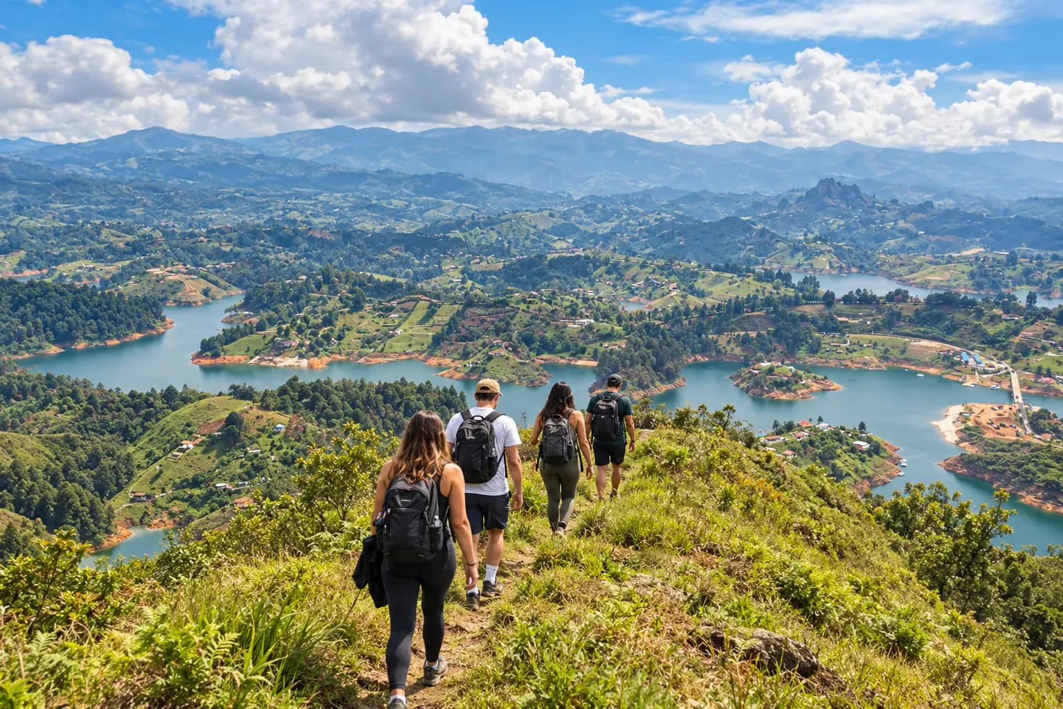 Travelers hiking along a green mountain ridge